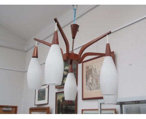 A teak "spider" five branch ceiling light fitting with white glass shades 