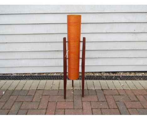 A 1960's orange fibreglass rocket lamp on three teak legs. 