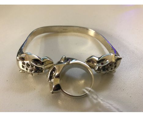 A silver panther ring with ruby eyes; together with matching bracelet