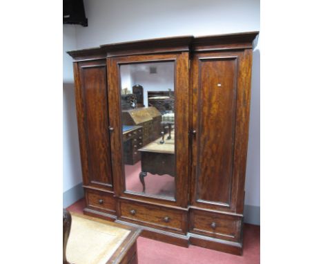 A Mid XIX Century Mahogany Breakfront Wardrobe, with stepped cornice, central mirrored door, with six internal drawers, flank