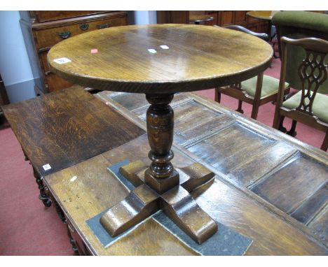 A Titchmarsh & Goodwin Oak Lamp Table, with joined oak circular top, on turned pedestal on four block supports, bearing label