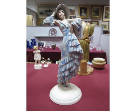 A Goldscheider Pottery Figure, depicting a young woman wearing a floral pattern summer dress and hat, circular base, printed 