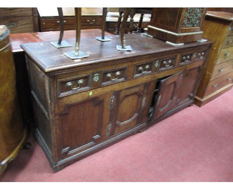 A Late XVII Century and Later Oak Dresser Base, with three frieze drawers over two cupboard doors, all with moulded front dec