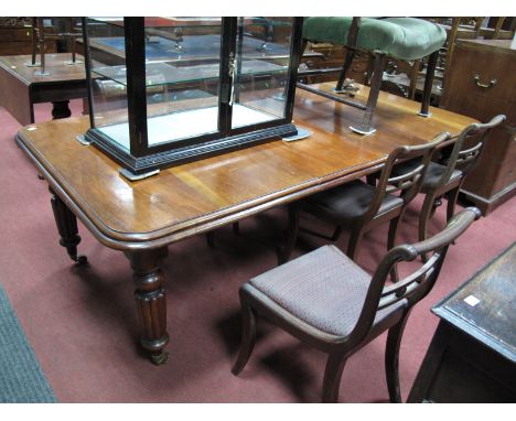 A Mid XIX Century Mahogany Wind-out Dining Table, on turned and gadrooned legs on brass and ceramic castors, with two extra l