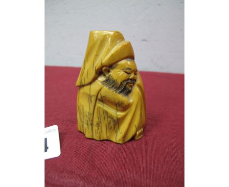 An Early XX Century Japanese Walrus Ivory Figure, depicting a sleeping immortal, seated, wrapped in a cloak, 6.3cms high.