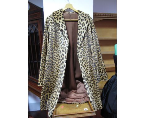 A C.1940's/50's Ladies Leopard Skin Coat, knee length with shawl collar and turn back cuffs to bell shaped sleeves, concealed