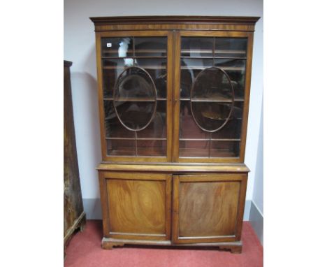 A Late XVIII Century Mahogany Book Cabinet, with stepped pediment, twin astragal doors and adjustable shelves over panelled c