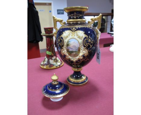 An Early XX Century Coalport China Two Handled Vase and Cover, painted and gilt with reserved oval landscape panels on a rich