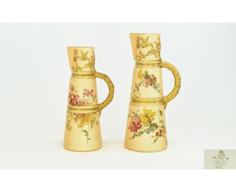 Royal Worcester Blush Ivory Pair Of Tapering Claret Jugs. Handpainted with gilt and floral decoration, the gilt handles in th