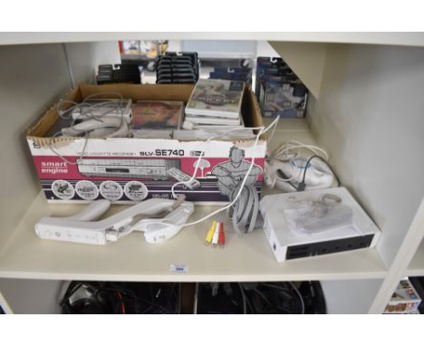 A Nintendo Wii Console with controllers and gun with cables and a collection of Games including Just Dance 2, 2009 Ashes Cric