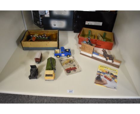 A shelf of mixed Toys including Hornby 0 gauge tin plate Platforms, Signals, Level Crossing, Dinky Catalogue, wooden Wolf and