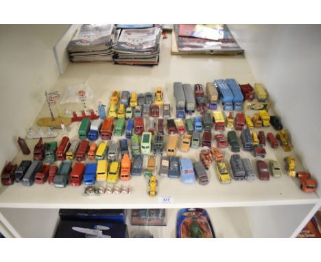 A shelf of playworn Matchbox Lesney die-casts, Commercial Trucks and Wagons, Cars, Buses etc, 80+ along with Dinky and Lesney