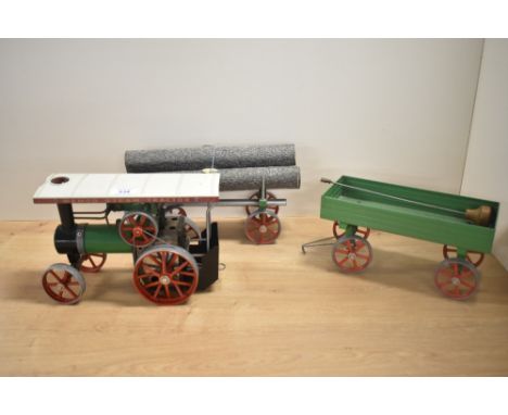 A Mamod Live Steam Tractor with Trailer and Log Trailer, burner present