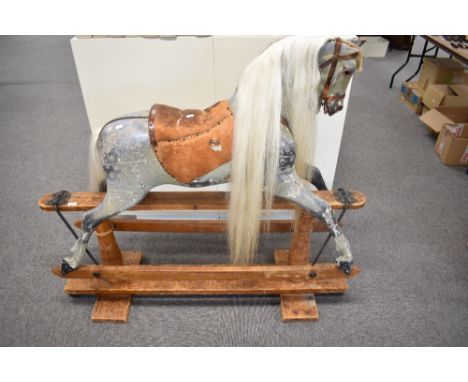 A Victorian Rocking Horse painted grey, having leather saddle and bridle, replacement mane and tail, damage to ears, on tradi