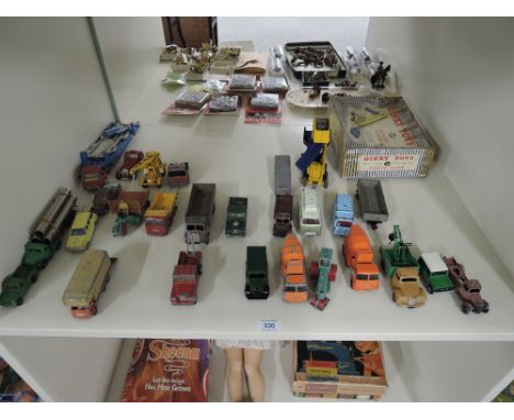 A shelf of playworn Dinky and Corgi die-casts including Dinky 564 Elevator Loader in worn original box, Fordson Trucks with o