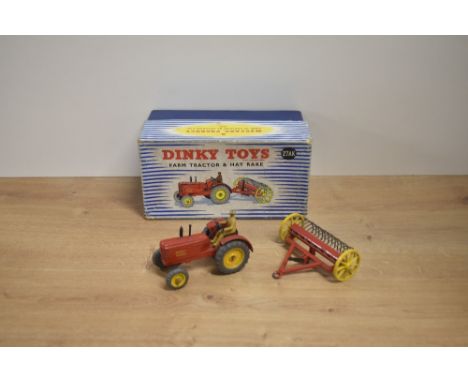 A Dinky die-cast, 27AK Farm Tractor &amp; Hay Rake in original blue and white striped box, driver present