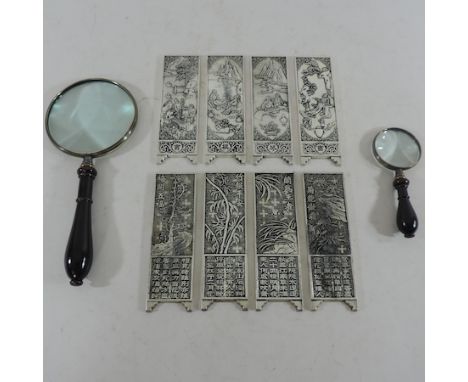 A set of eight white metal Chinese manuscript weights, together with two magnifying glasses