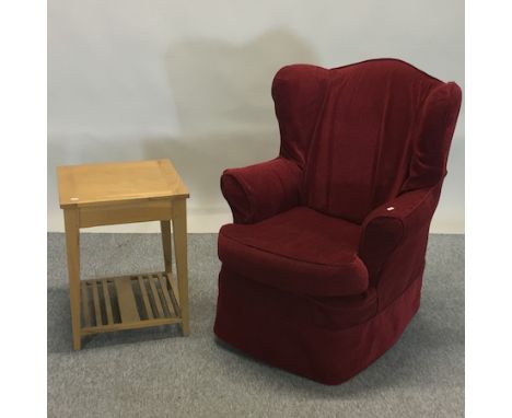 A red upholstered armchair, together with a light oak occasional table, 46cm