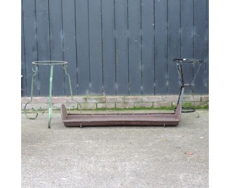 A cast iron pig trough, 125cm, together with a green painted metal plant stand, and another