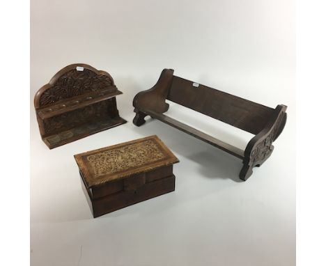 An oak book rack, 51cm, together with a carved pipe rack and an inlaid box