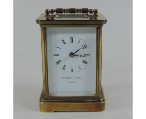 A brass carriage clock, inscribed Matthew Norman, London 12cm high
