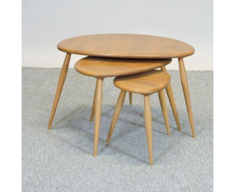 An Ercol light elm nest of three pebble shaped occasional tables, largest 63cm