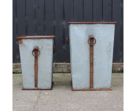 A galvanised planter, 82cm diameter, together with another smaller