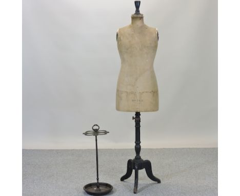 An antique French mannequin, 166cm tall, together with a cast iron stick stand