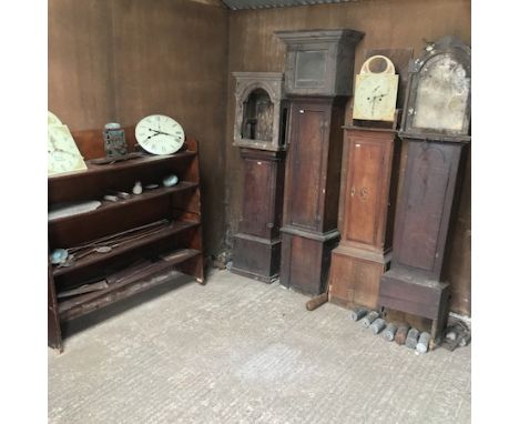 An 18th century longcase clock case, together with three other cases and various movements, weights and pendulums, together w