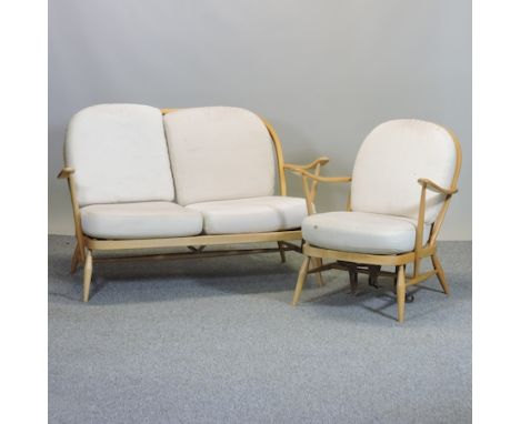 An Ercol light elm two seat sofa, 136cm, together with a matching armchair