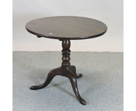 A George III style mahogany occasional table, having a circular top, on a tripod base, 64cm