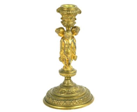 A 19TH CENTURY GILT BRASS CANDLESTICK, THE SCONCE SUPPORTED BY THREE YOUNG GRAPE HARVESTERS WITH LINKED ARMS, 20CM H