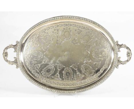 A VICTORIAN OVAL EPNS TEA TRAY, ENGRAVED WITH THE INITIAL R, PIERCED SCROLLING HANDLES, 69CM WIDE