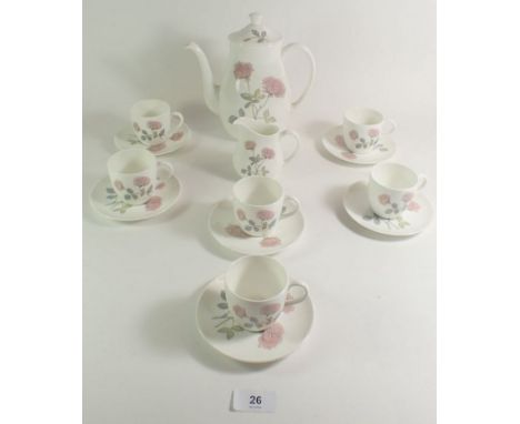 A Wedgwood 'Flame Rose' coffee set comprising six cups and saucers, coffee pot and cream jug 