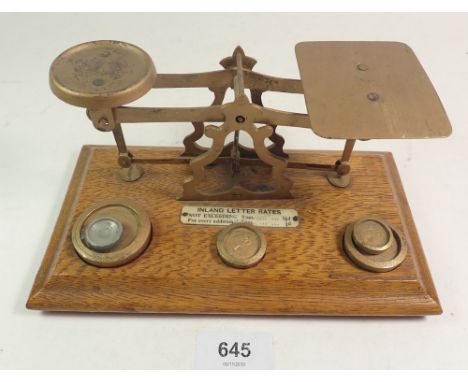 A set of brass and oak postal scales 