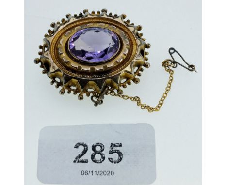 A Victorian yellow metal oval brooch set amethyst 