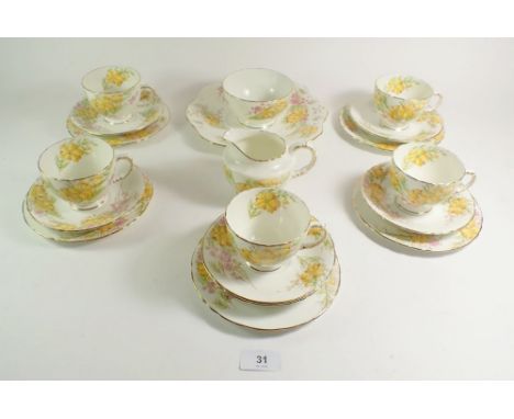 A Sutherland tea service comprising: five cups and saucers, five tea plates , cake plate , milk jug and sugar bowl 