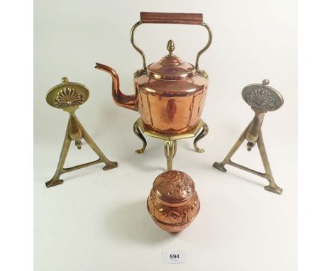 A Victorian copper kettle with acorn finial, a brass trivett, two brass fire dogs and an Arts &amp; Crafts embossed copper te