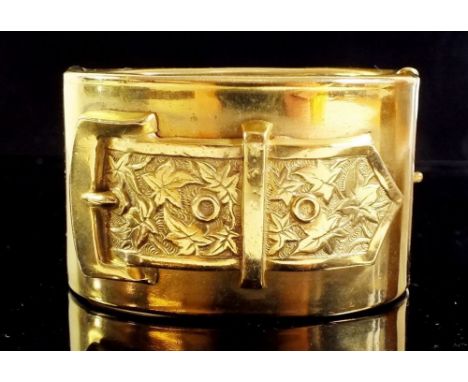 A Victorian gilt metal wide hinged bangle with buckle decoration, 38 cm wide 