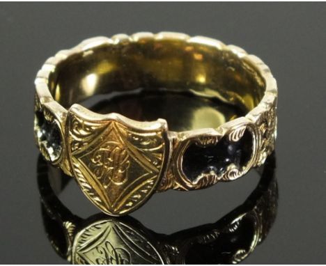 A Georgian mourning ring with shield flanked by floral engraving and black enamel decoration to band 