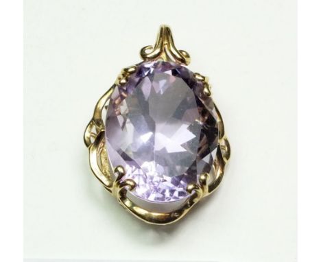 An amethyst oval cut pendant in decorative 9 carat gold mount, 2.7 x 2cm 