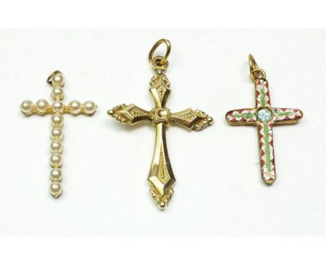A yellow metal crucifix, a micro mosaic crucifix and a pearl set one 