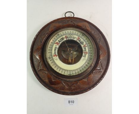 A carved mahogany circular barometer 