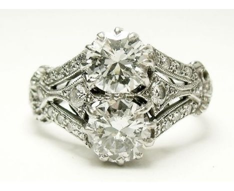 A fine Art Deco 18 carat white gold ring set two diamonds on triple diamond set shoulders, 4.7g, size J to K 