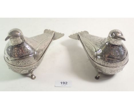 A pair of Persian silver plated trinket boxes in the form of exotic birds decorated in a chased form of flowers. 19cm long. 