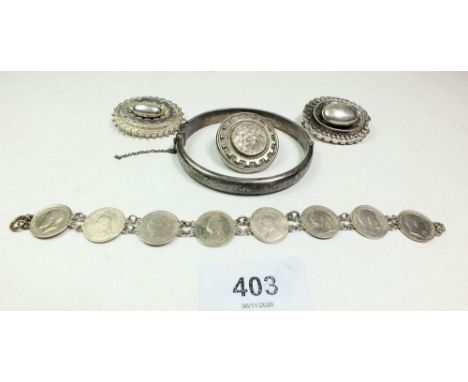 A silver bangle, three Victorian silver brooches and a coin bracelet 