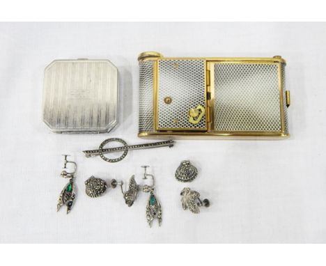 Combination musical compact with cigarette compartment, compact section and lipstick container, with gilt and snakeskin-effec