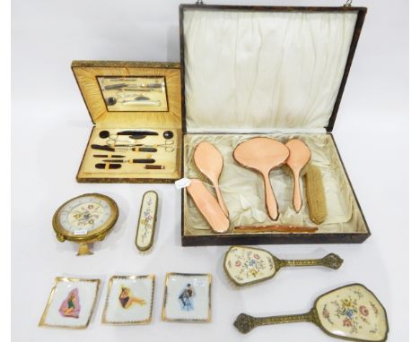 Cased dressing table set with peach enamel backs and gilt metal borders, a cased manicure set, a dressing table set comprisin