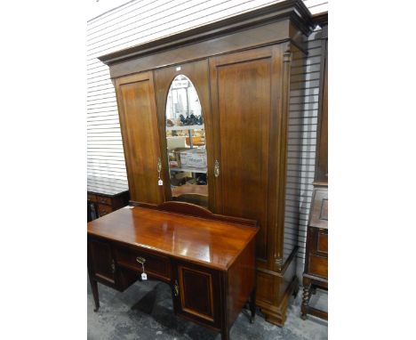 Edwardian mahogany and line inlaid wardrobe having flat moulded cornice, rhomboid inlaid frieze, the centre panel with oval b