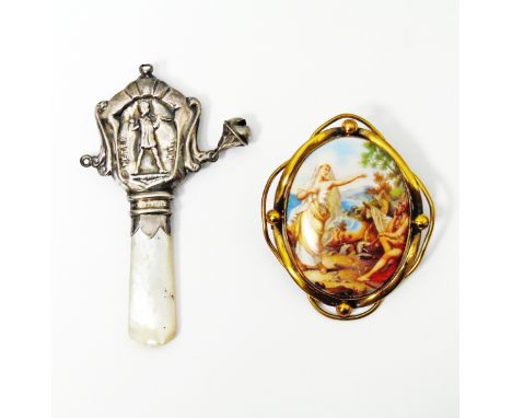 Victorian brooch with central printed porcelain oval depicting figures on a coastline, in rolled gold frame mount and a silve